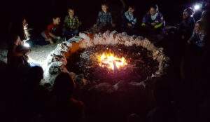 Small group gathered around a campfire