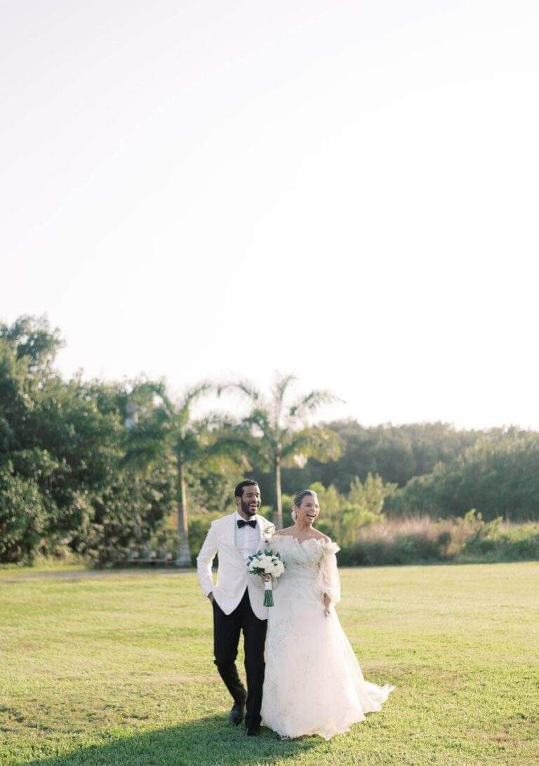 Couple during golden hour at Deering Estate's Grand Waterfront Lawn with greenery in the background