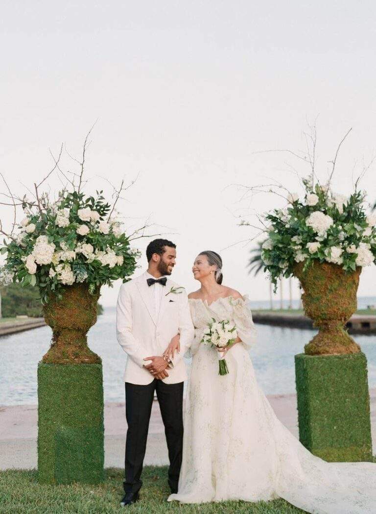 Couple at their ceremony altar at Deering Estate's Grand Waterfront Lawn