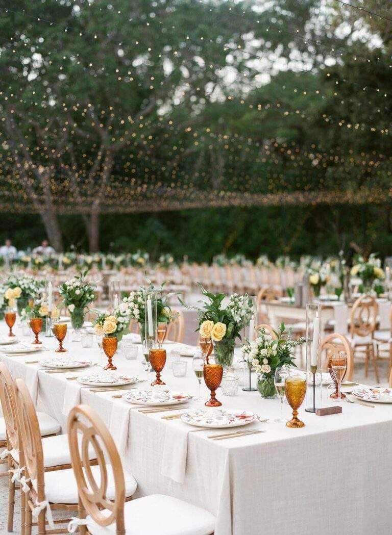 Dinner reception overview at Deering Estate's Corutyard with twinkling lights strung above
