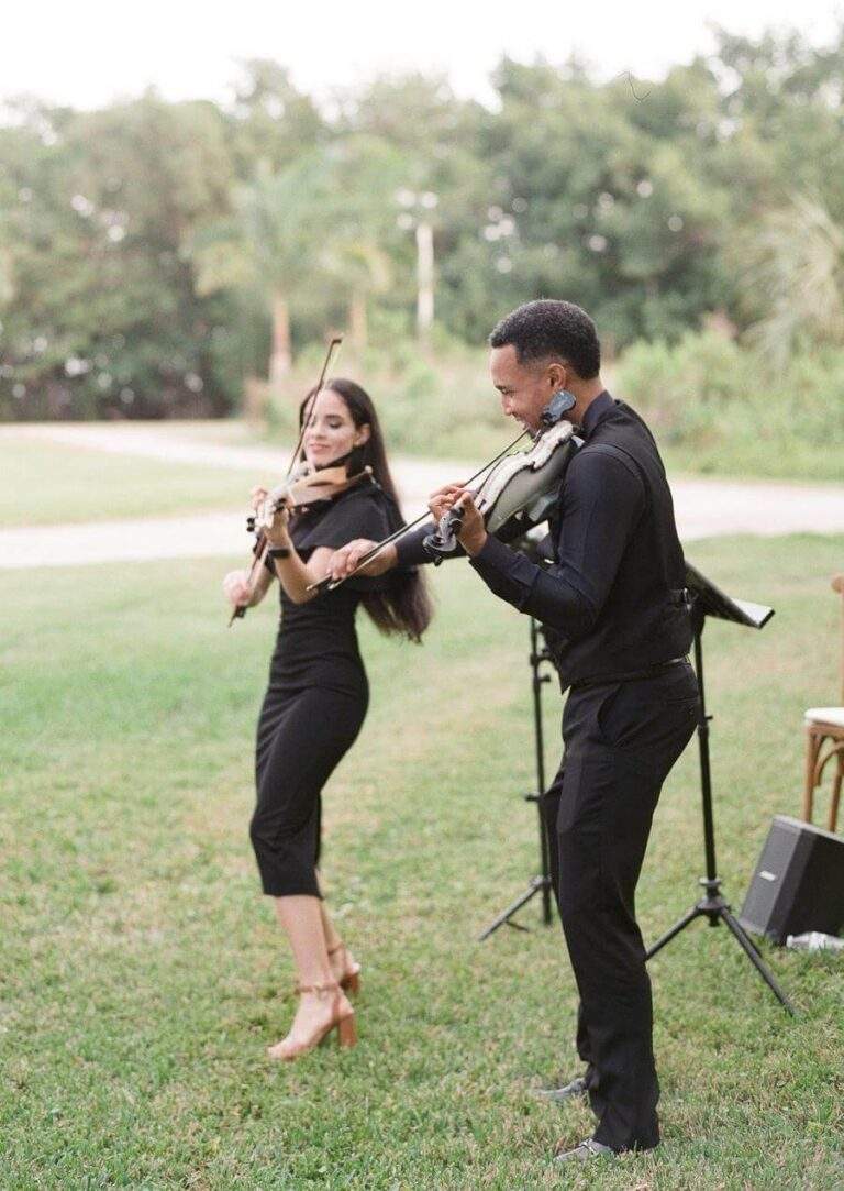 Violinists performing at the cocktail-hour at Deering Estate's Richmond Cottage Museum's lawn