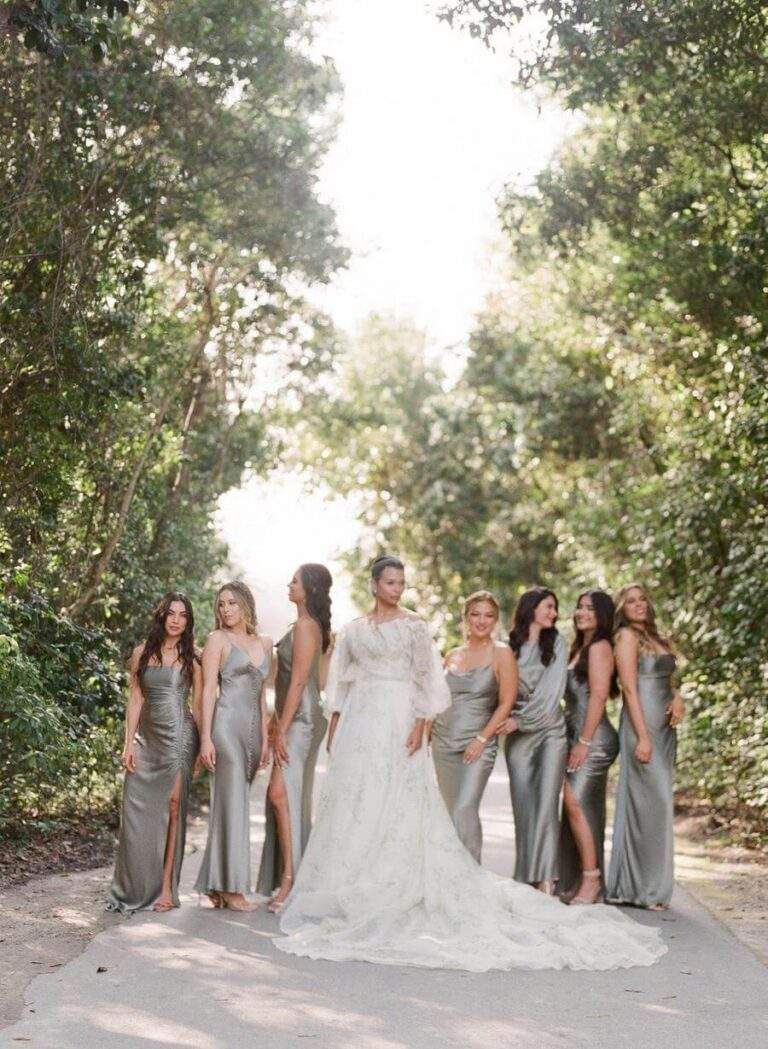 Bride and bridal party at Deering Estate's garden pathway