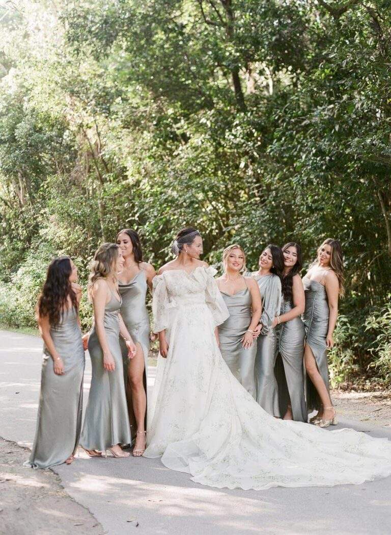 Bride and bridesmaids at Deering Estate's garden pathway