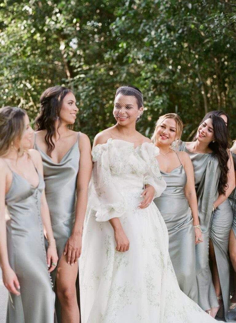 Bride and bridesmaids at Deering Estate's lush garden pathway