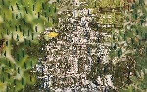 A photo of mangroves and water with embroidery of running stitches over it. This is a piece by Pangea Kali Virga.