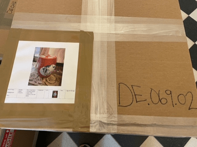 A Stone House collection piece in a sealed cardboard box with a catalog number on the outside of it.