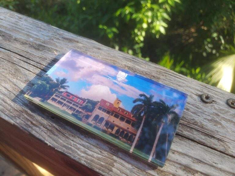 A magnet with the Deering Estate logo at the top over an image of the front of the Richmon Cottage and Stone House.