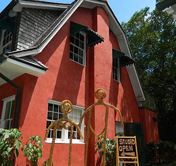 Human-like woven structures on display in front of the artists studio at Deering Estate.