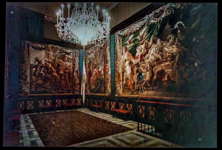 Color plate Auto-chrome slide of the interior of Maricel with Charles Deering's tapestry collection illuminated by a bright crystal chandelier.