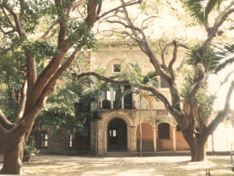 Lush trees shading the courtyard behind Charles Deering's Stone House during the 1980's.
