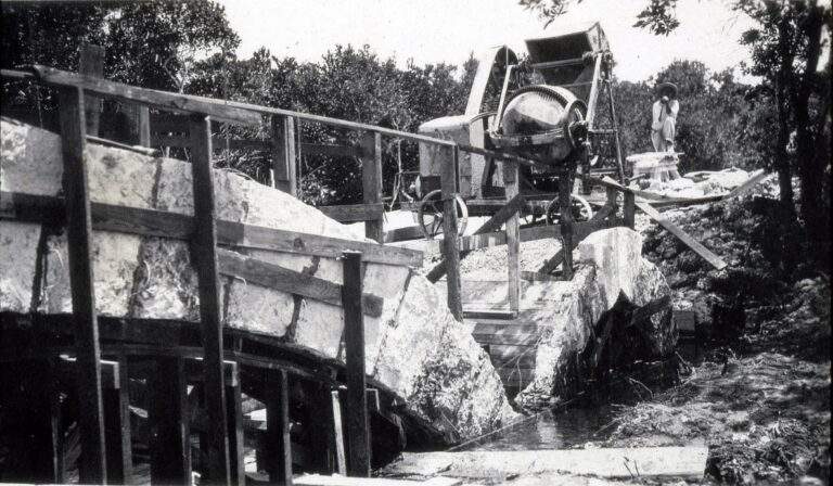 Worker posing with concrete mixer during construction of the Chinese Bridge in 1916 on today's 72nd Avenue.