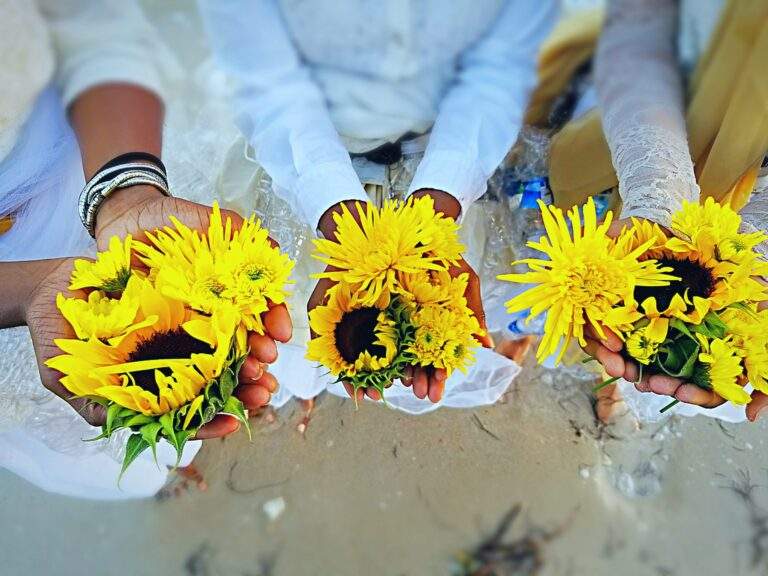 Group of people holding sunflowers