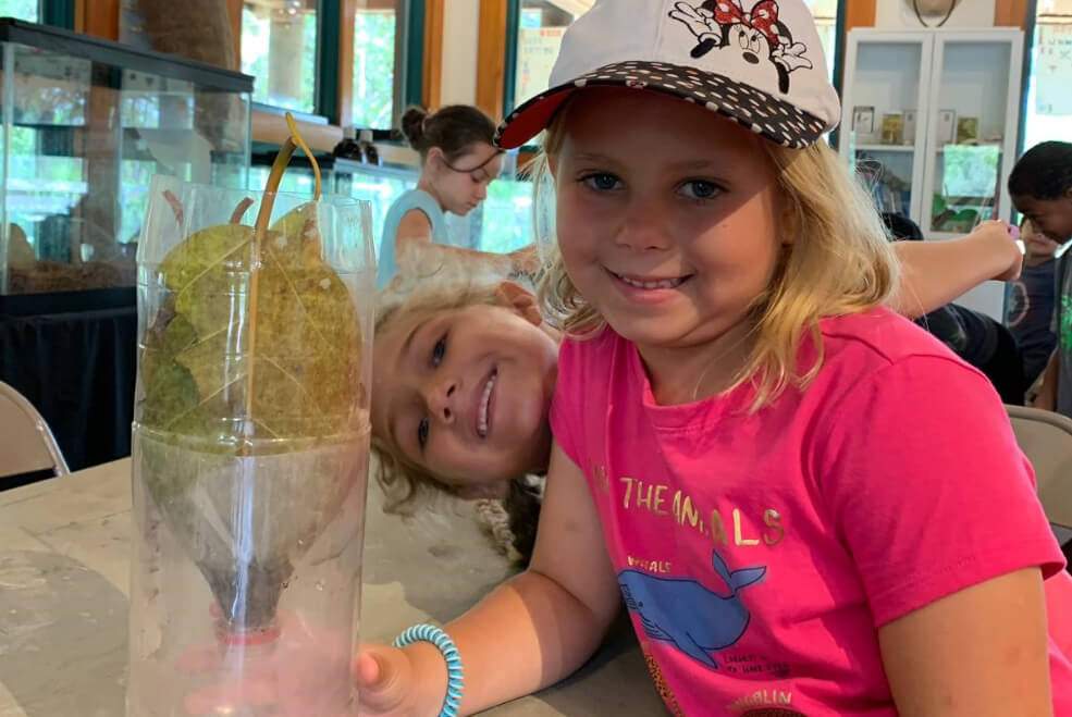 Kids learning how to filter water on their interactive field trip.
