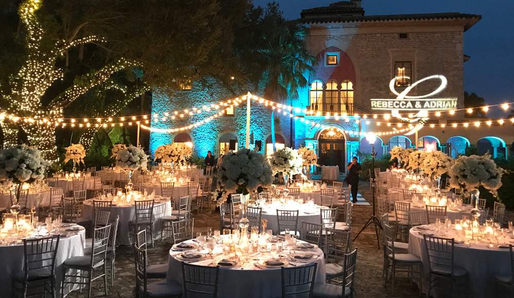 Decorative string lights covering the Stone House courtyard for an intimate wedding reception.