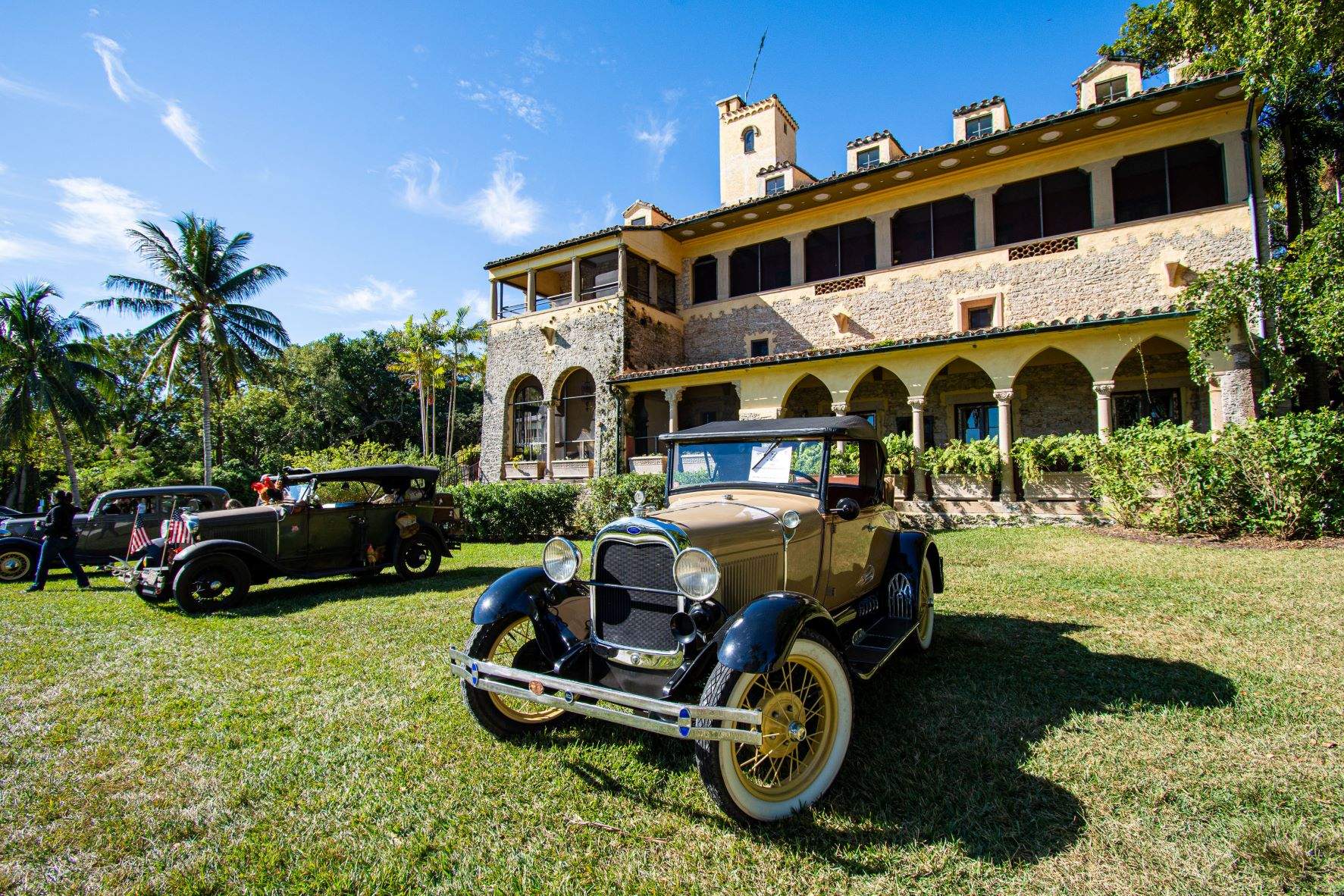 Vintage cars parked in front of the Stone House during the Annual Vintage Auto Show at Deering Estate.