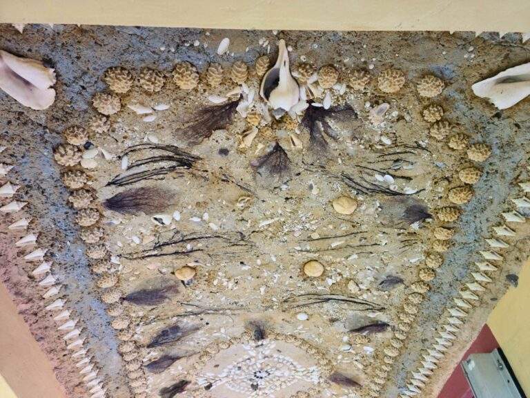 Beautifully detailed seashell mosaic on the ceiling of the Stone House walkway.