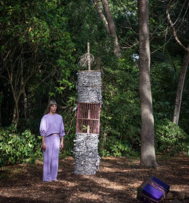 Artist Maria Theresa Barbist stands next to her art piece titled "Babylonischer Turm I-V (Deering Estate)."